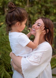 mom holding baby smiling - WeNatal Prenatal